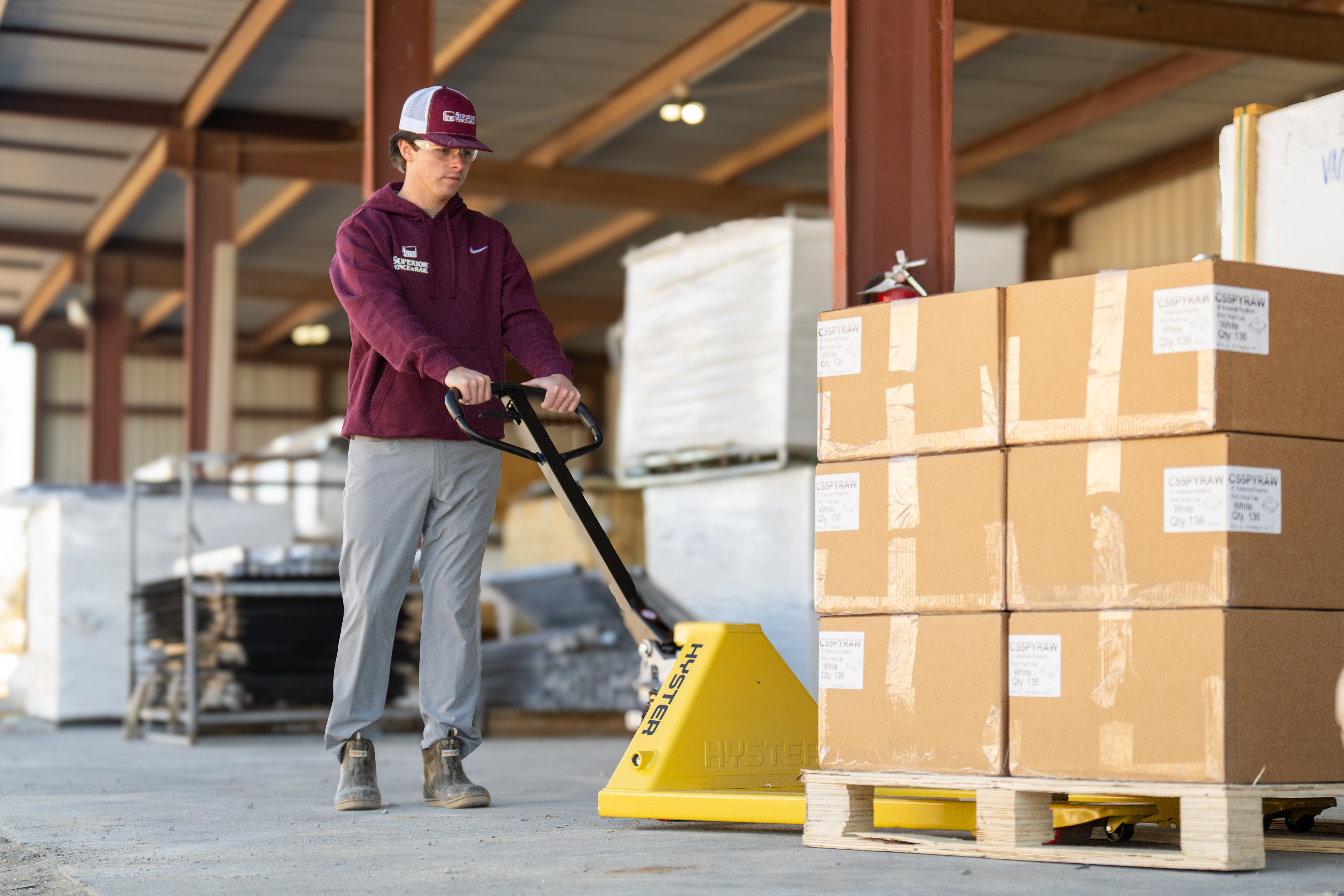 A forklift operator looks through overhead guard