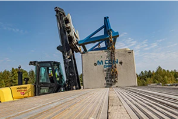 hyster truck lifting a concrete block