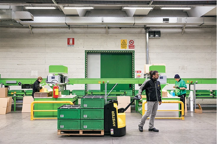 Man with pedestrian forklift truck