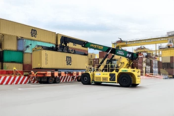 Hyster electric container handler, a type of cargo handling equipment, operating in a container yard