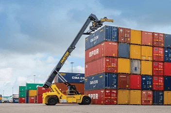 Hyster ICE container handler performing cargo handling operations near a stack of containers