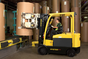 A Hyster forklift with a paper roll clamp in action