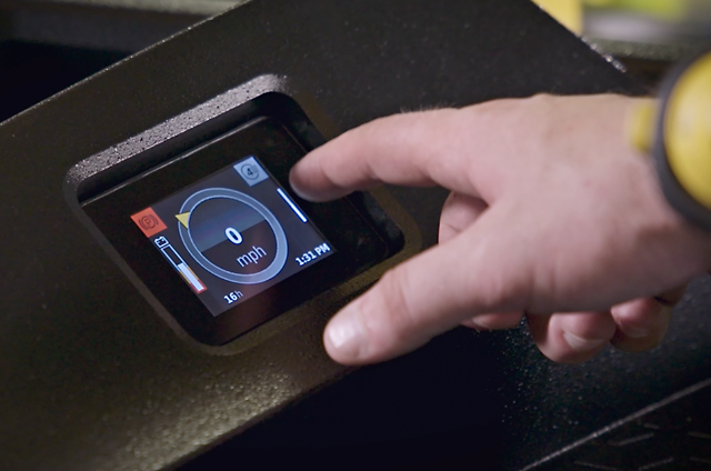 Forklfit operator prepares to press a button on a touchscreen 